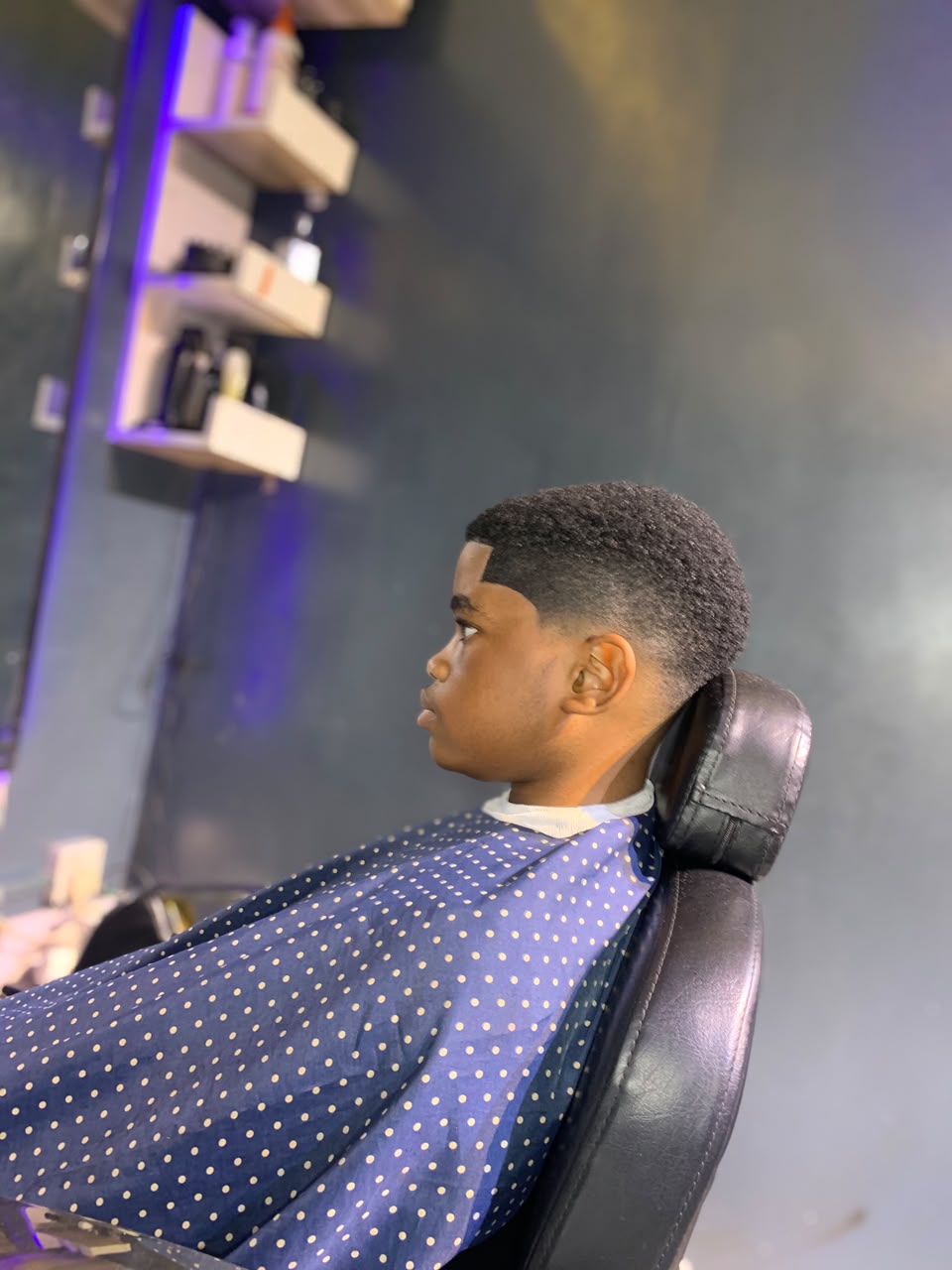 Side view of a textured haircut with tapered sides